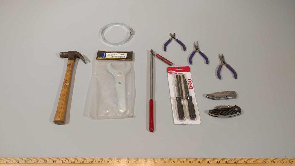SMALL PLIERS, SHOCK ADJUSTING TOOL, EXTENDABLE MAGNET, KNIVES, AND TIRE PLUG KIT