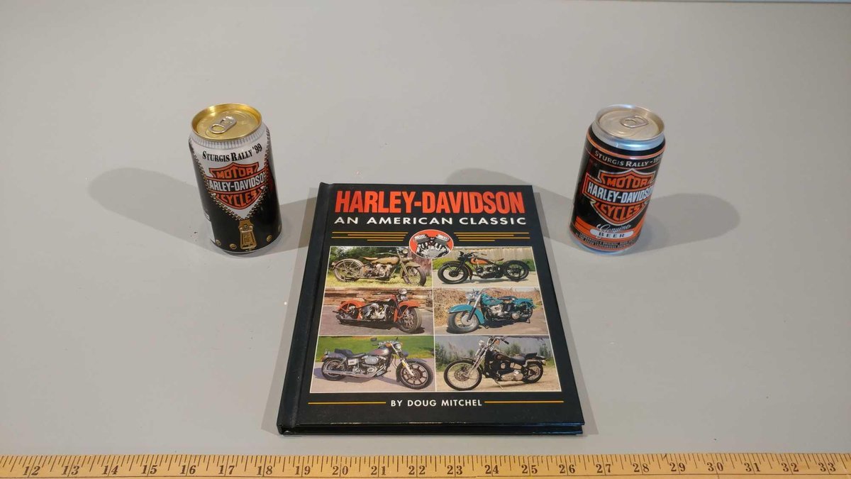 HARLEY-DAVIDSON AN AMERICAN CLASSIC HARD COVER BOOK, & (2) HARLEY-DAVIDSON BEER UNOPENED BEER CANS)