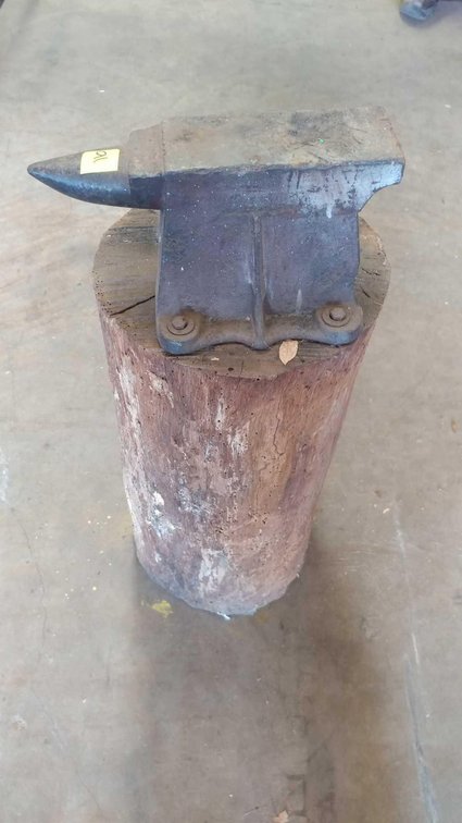 ANVIL ON WOOD TRUNK