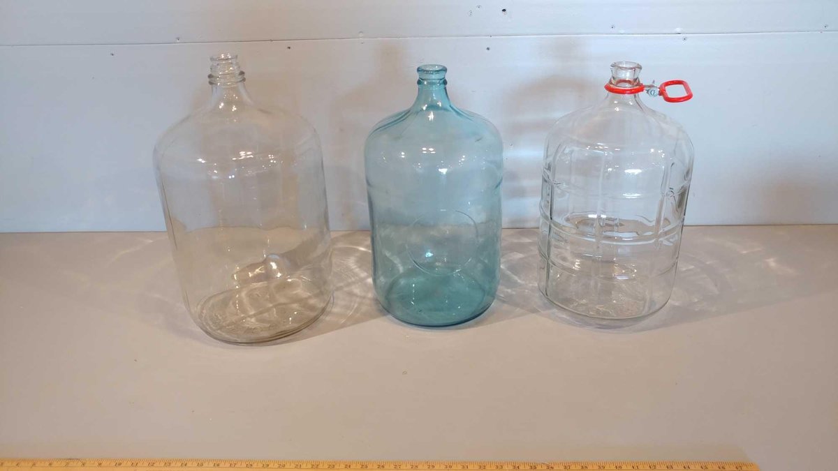 (3) LARGE GLASS JUGS (ONE WITH HANDLE)