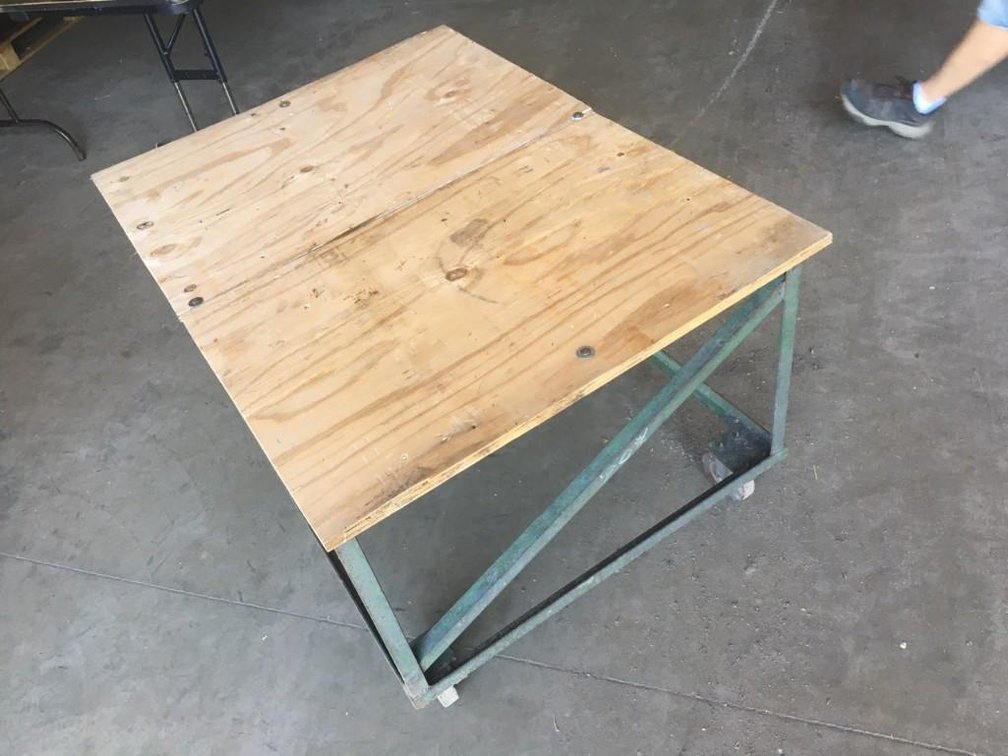 (I-207) ROLLING TABLE 48" X 35"  ON 5" SWIVEL CASTERS, WITH 3/4" PLYWOOD TOP (LOCATED SOUTH OF STARB