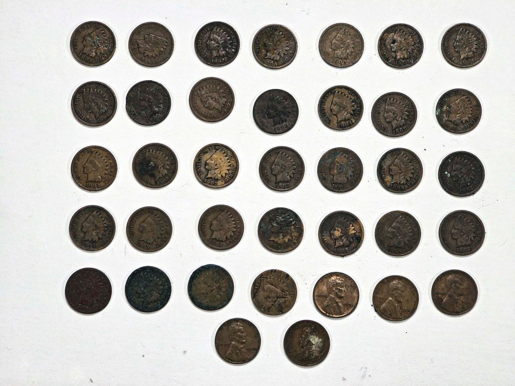 32 Indian Head Pennies, 4 Wheat Pennies, and 1 Can