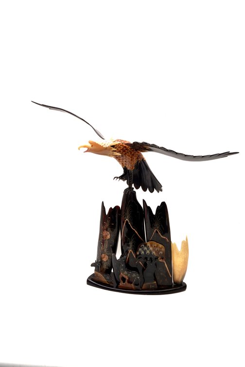 Carved Horn Eagle Sculpture on Mountain Scene