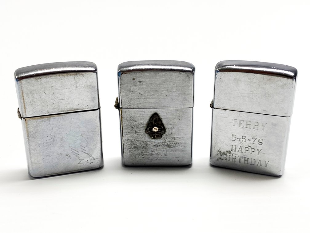 Three Zippo Lighters with Custom Engravings and Symbols