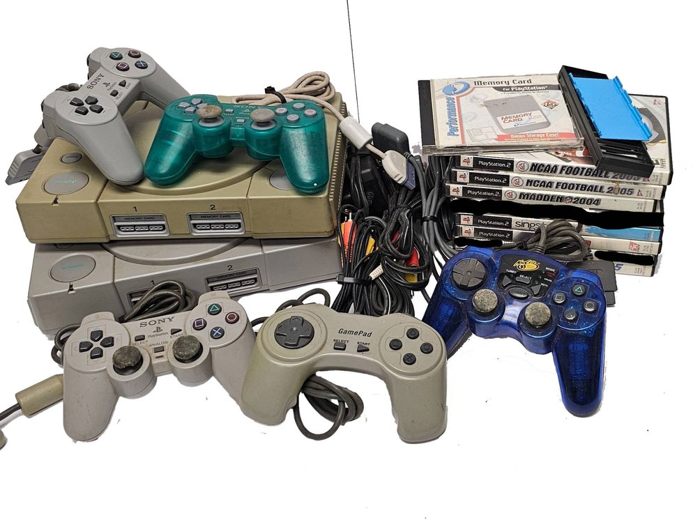 Sony PlayStation Consoles with Controllers, Memory Cards, and Games