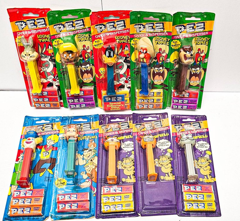 Vintage PEZ Dispensers in Sealed Packaging, Including Looney Tunes, The Flintstones, and Garfield Designs