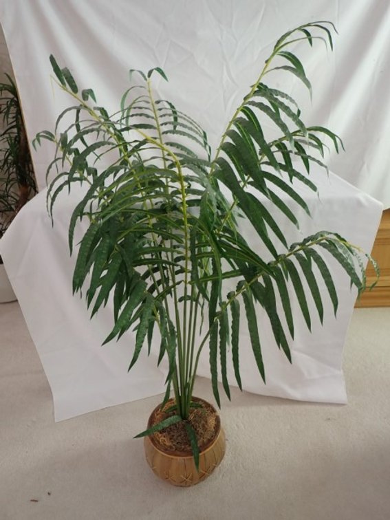 Faux plant with palm leaf pot
