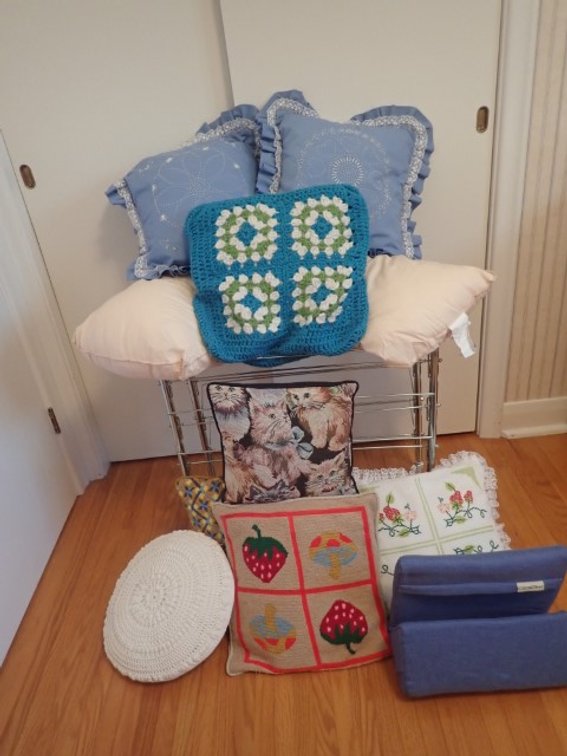 Assortment of Decorative Pillows with a Vintage Shoe Rack