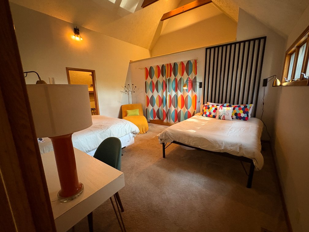 Two Beds, Chaise Lounger, Desk, Chairs (Iron Wall Decor Behind Bed Not Included)