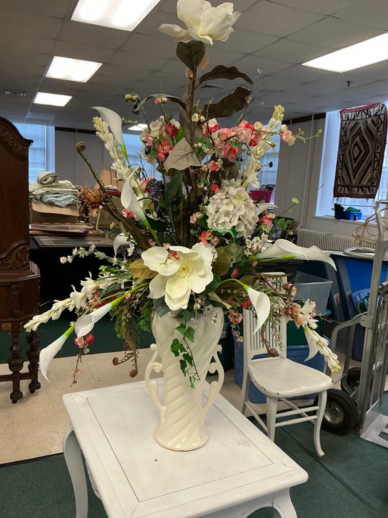 Large decorative floral arrangement in ceramic twisted vase