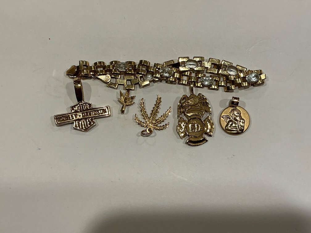 14K Gold Bracelet with Assorted Charms Weighing 15.5 Grams