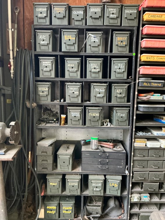 Organized Wall of Labeled Ammo Cans and Contents Including Tools and Parts
