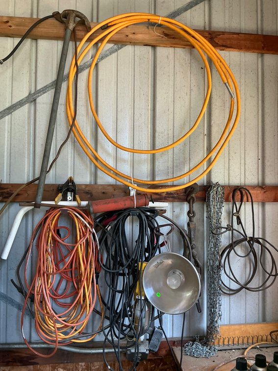 Assortment of Tools, Cords, and Utility Equipment from Storage Wall