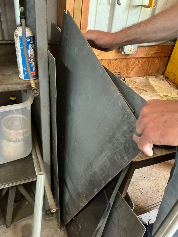 Assortment of Metal Sheets, Tubing, and Components for Workshop Use