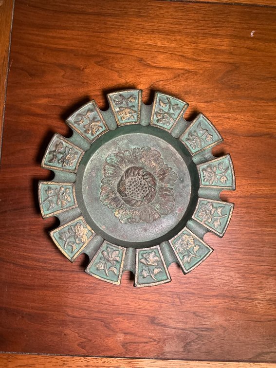 Metallic Ashtray With Decorative Motifs and Central Medallion Design