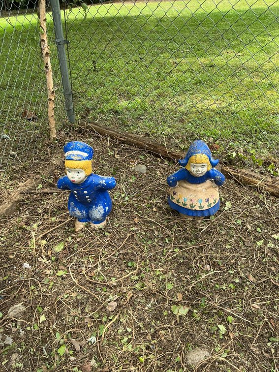 Hand-Painted Concrete Figures with Wear from Outdoor Display