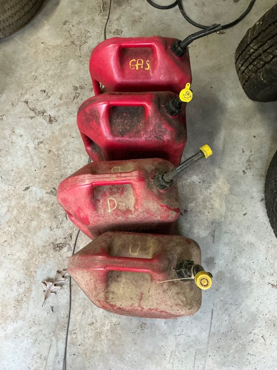 Four Red Gasoline Cans of Mixed Capacity and Usage