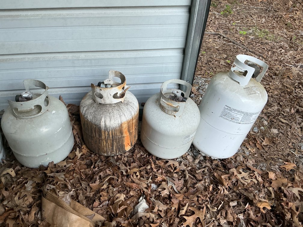 Four Propane Tanks with Varying Fill Levels