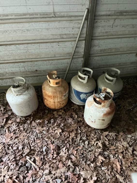 Five Propane Tanks with Varying Fill Levels