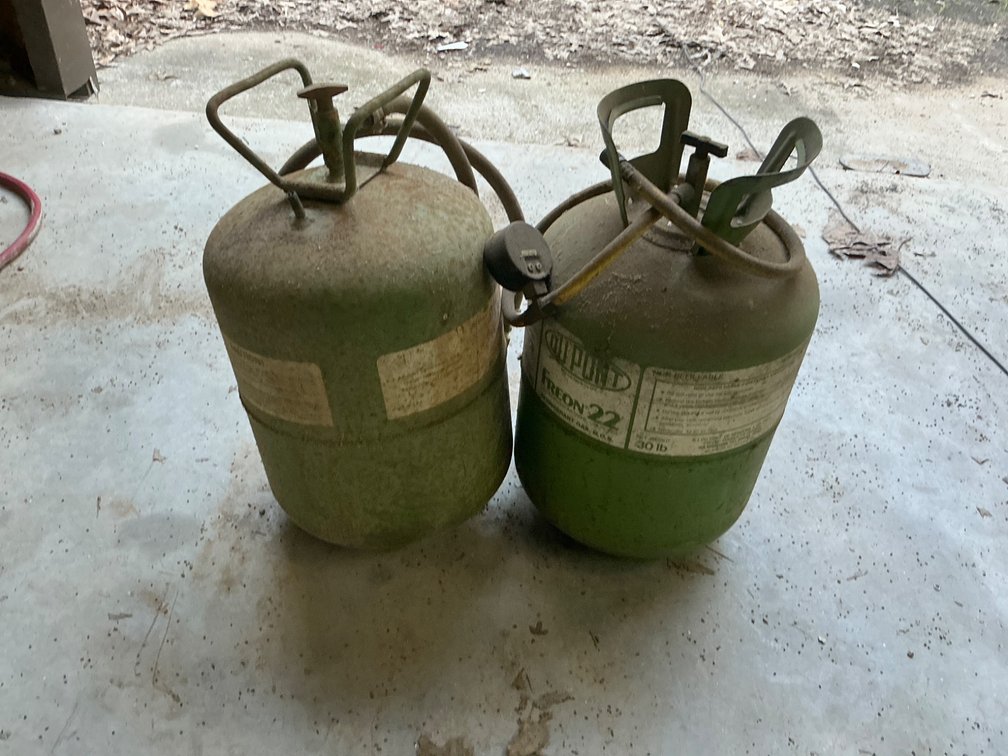 Two Mostly Empty Refrigerant Tanks with Attached Hoses