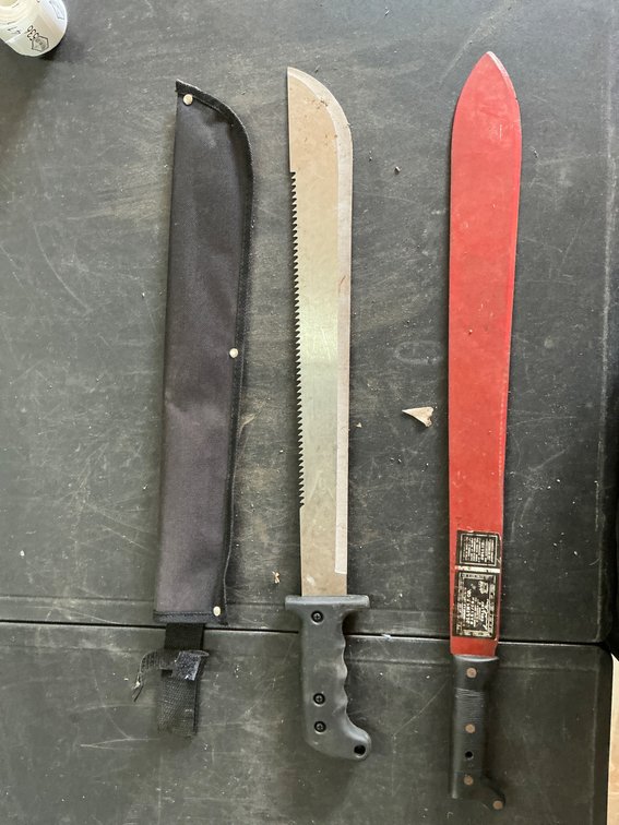 Two Machetes with Sheath and Manufacturer Markings