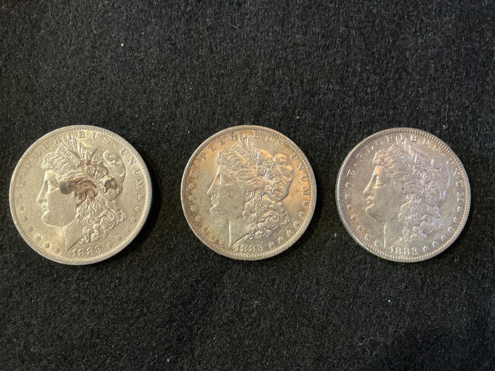 Three 1883 Morgan Silver Dollars with New Orleans Mint Marks