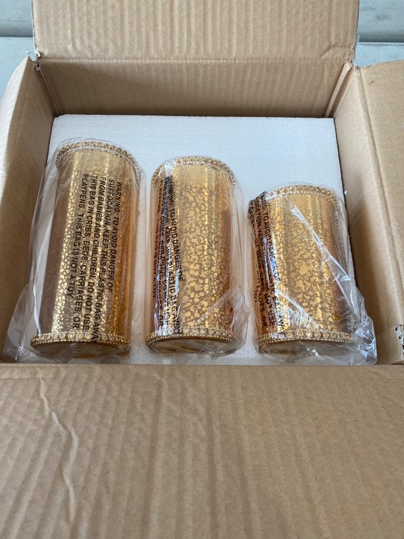 Three Gold-Toned Candle Holders in Original Packaging