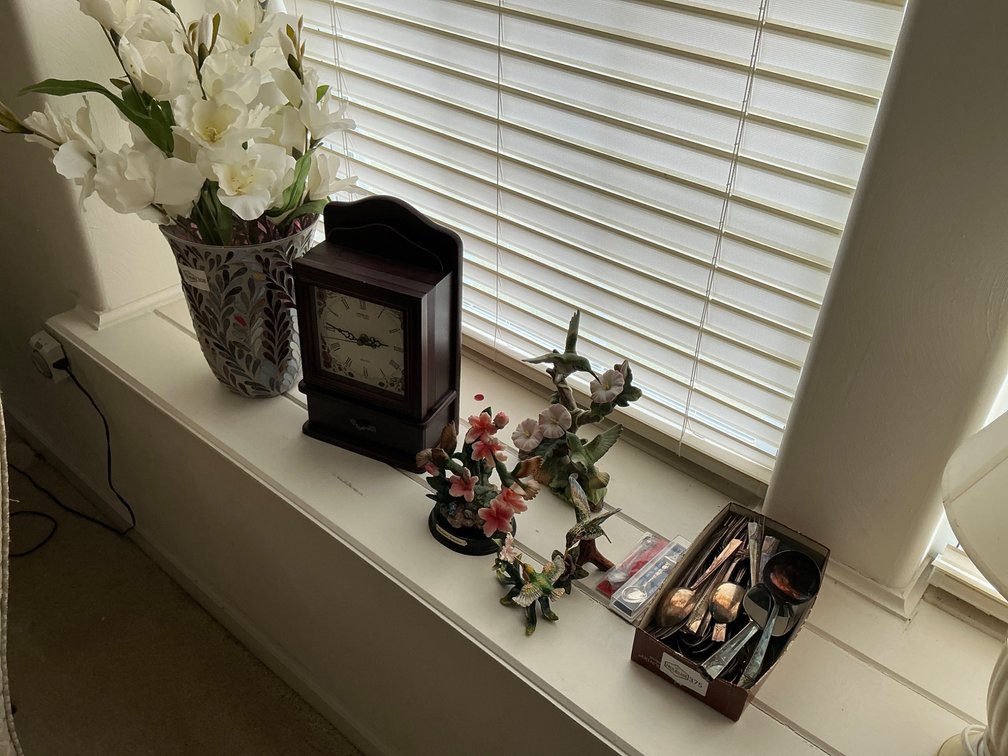 Decorative Pieces Including Clock, Figurines, and Silverware