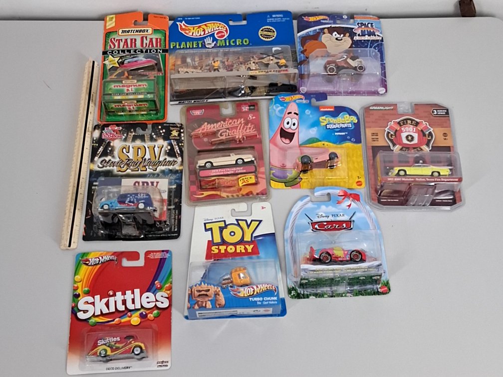 10 toy cars in packaging incl. Skittles, Disney,
