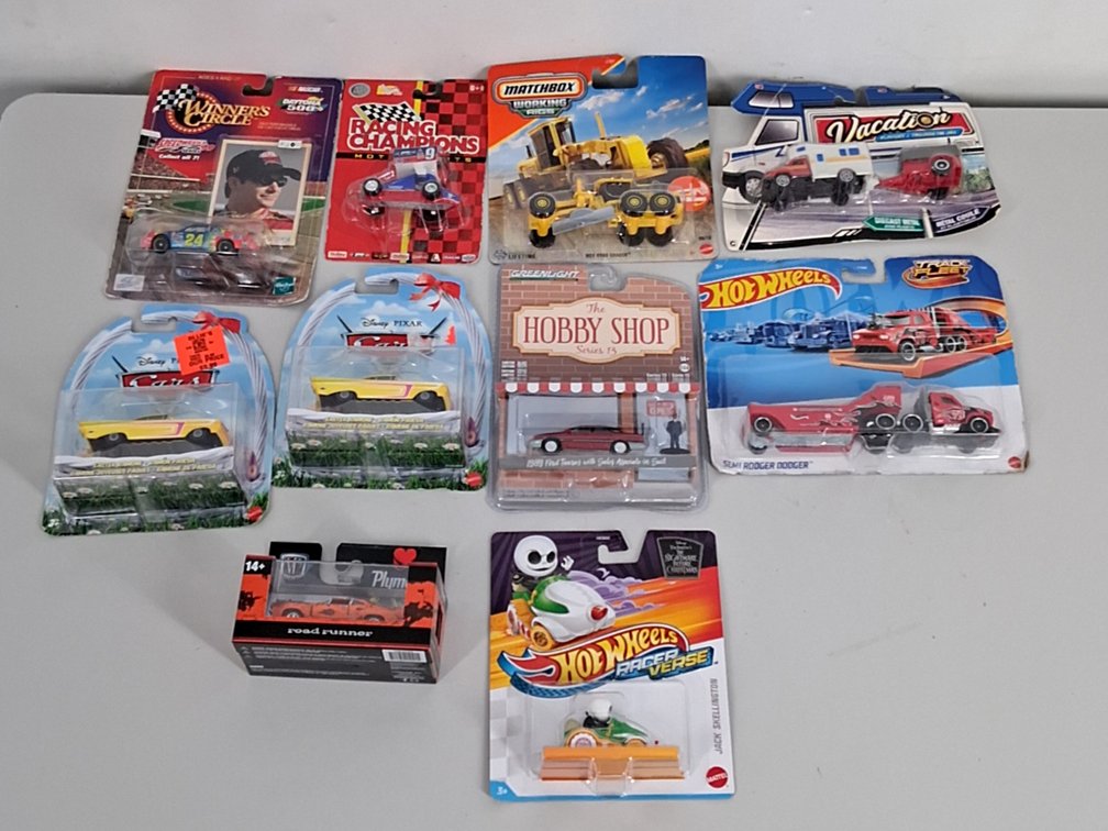 10 toy cars in packaging incl. Disney, Hotwheels,