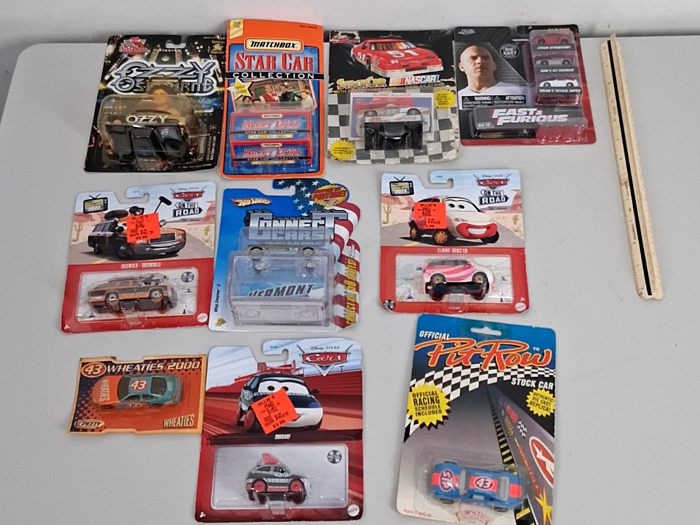 10 toy cars in packaging incl. Disney, Matchbox,