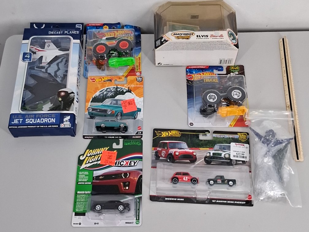 lot of toy cars, planes, and monster trucks in
