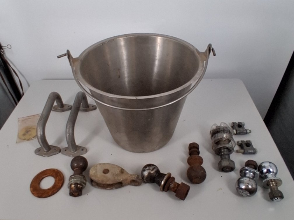 metal bucket of trailer hitcher balls,
