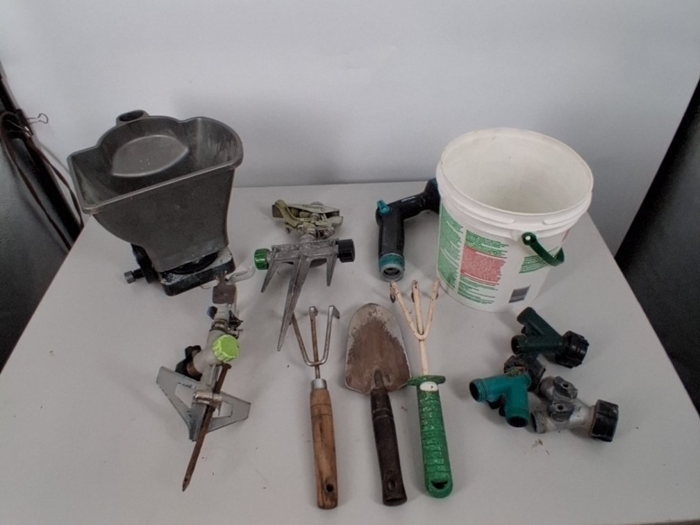 lot of hand seed spreader, sprinklers, hose