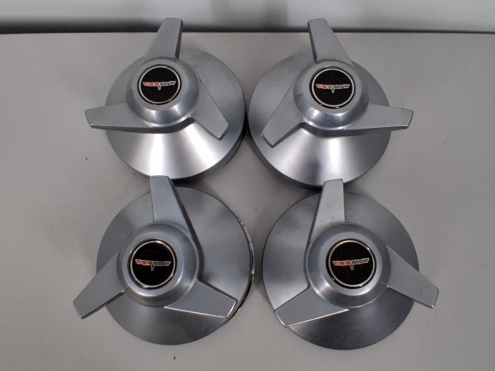 4 vintage Corvette hubcaps