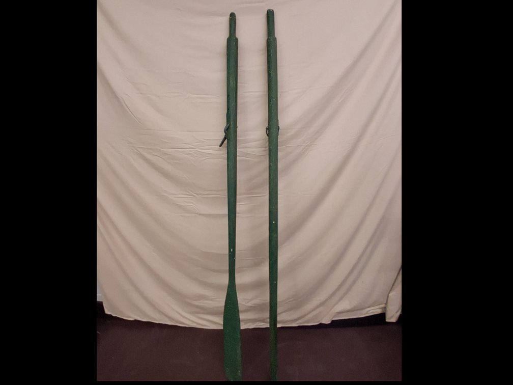 pair of vintage wooden oars painted green