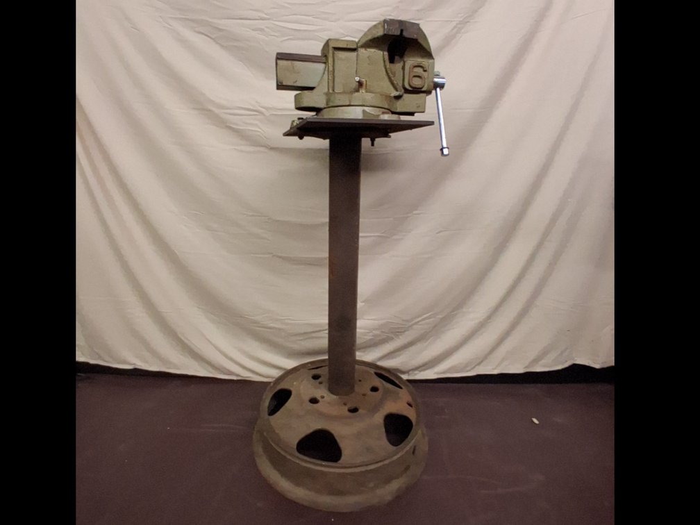 large bench vice marked 6 on a homemade
