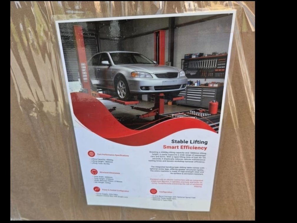 Red 10,000lb hydraulic two-post automotive car lift