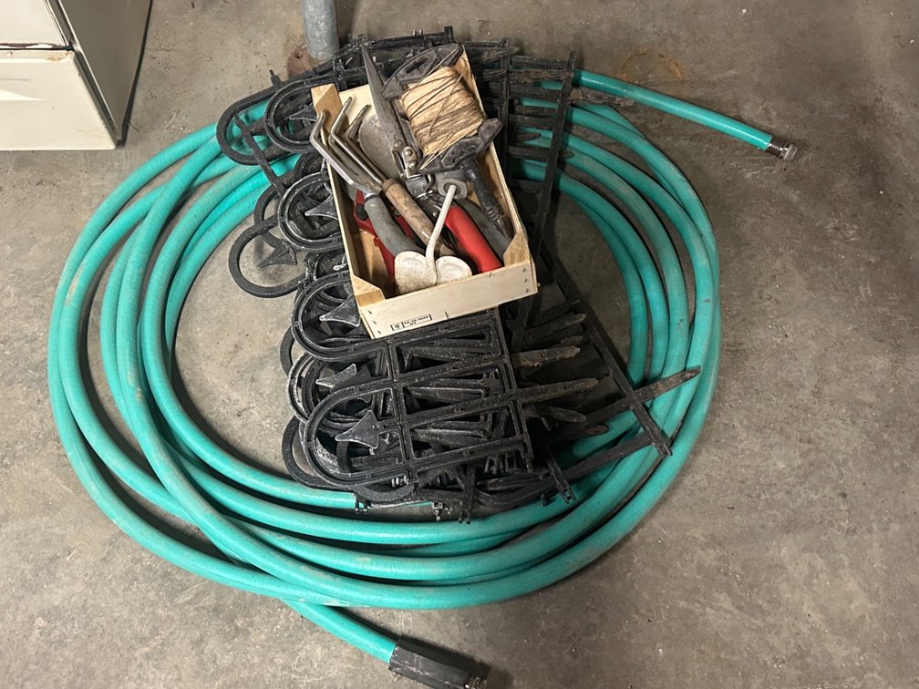 Garden hose, flower bed fence, garden tools
