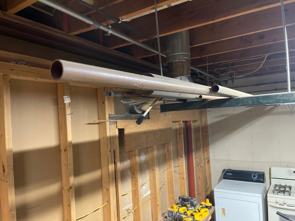 Copper pipe and misc. on rack in basement garage