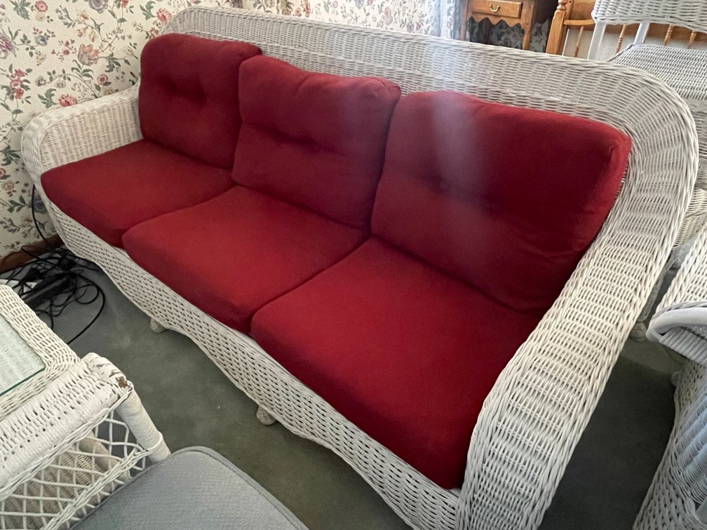 Wicker Sofa with dark red cushion