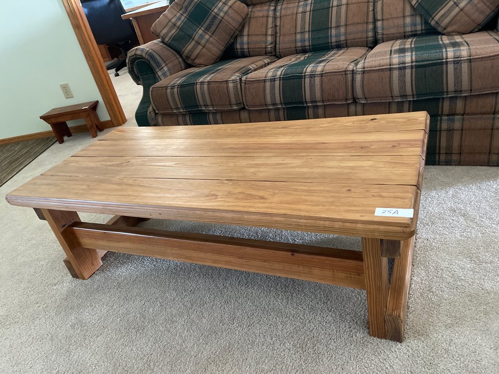 Coffee table by plaid couch 