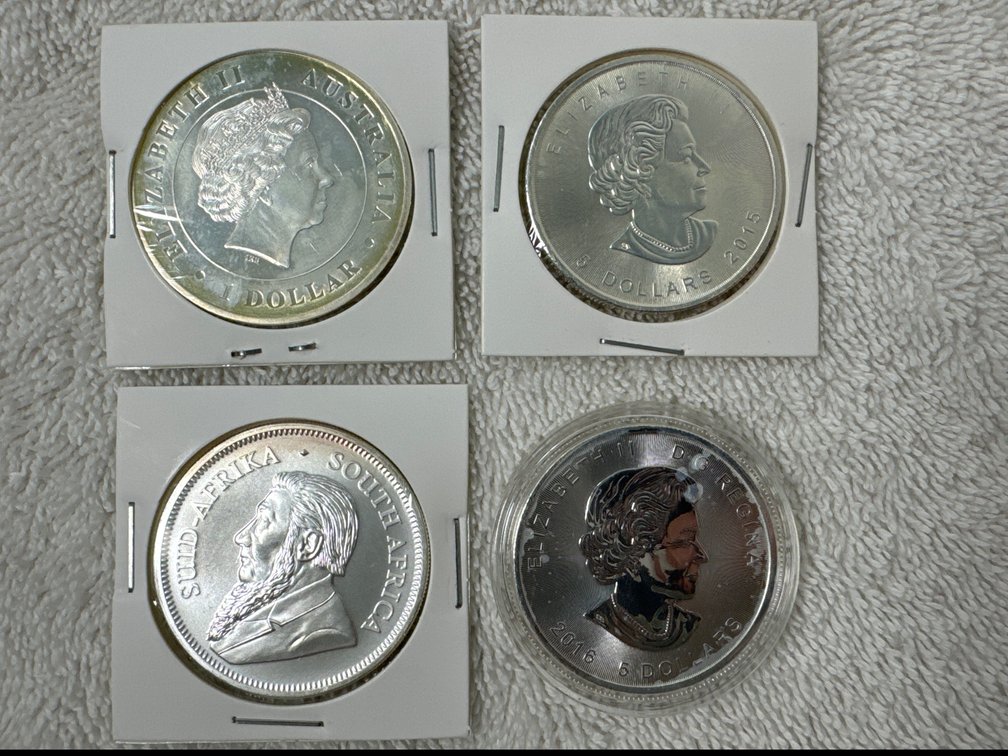 Four silver coins, all foreign