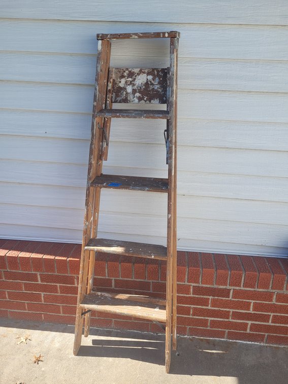 Wooden ladder and snow shovels