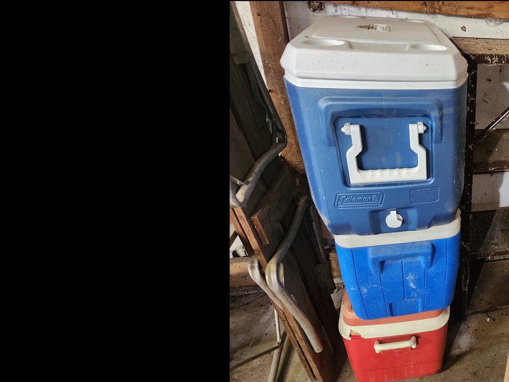 3 coolers a metal shelf