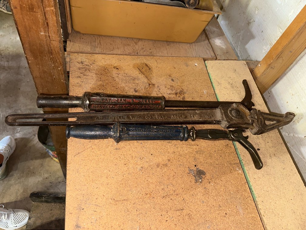 2  vintage nail pullers, and a  vintage wire stretcher