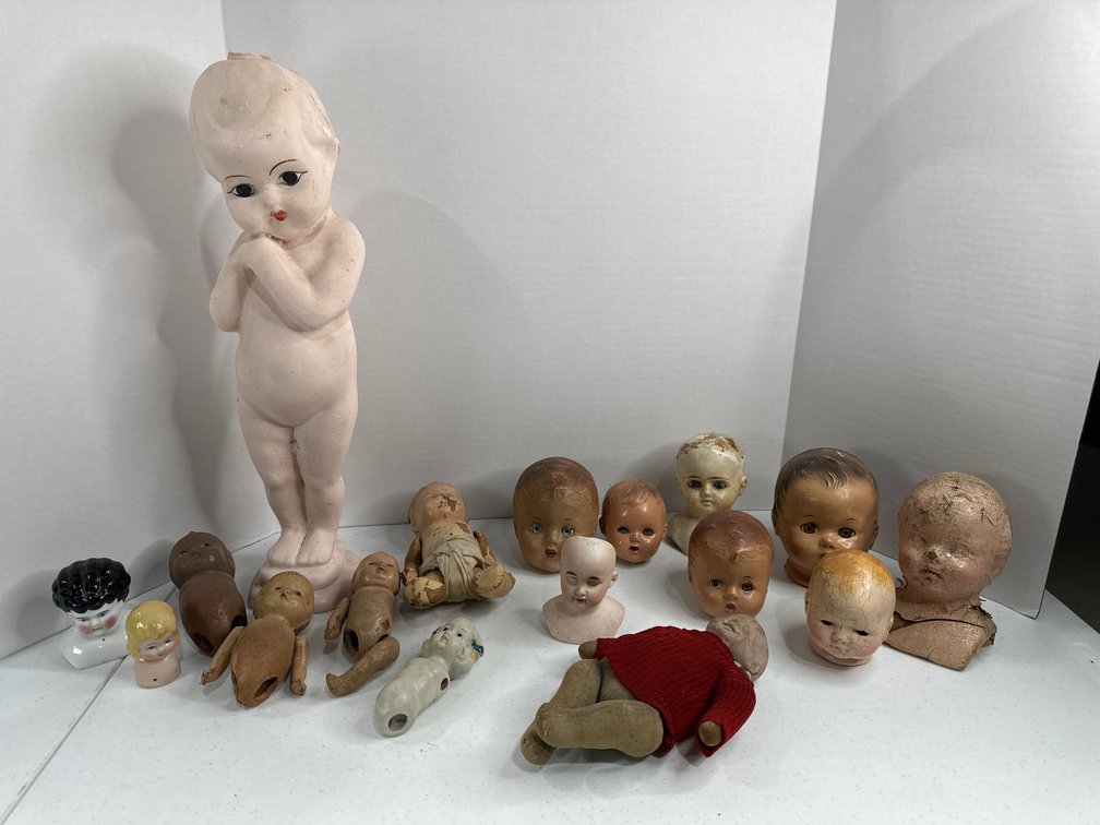 flat of creepy doll heads 