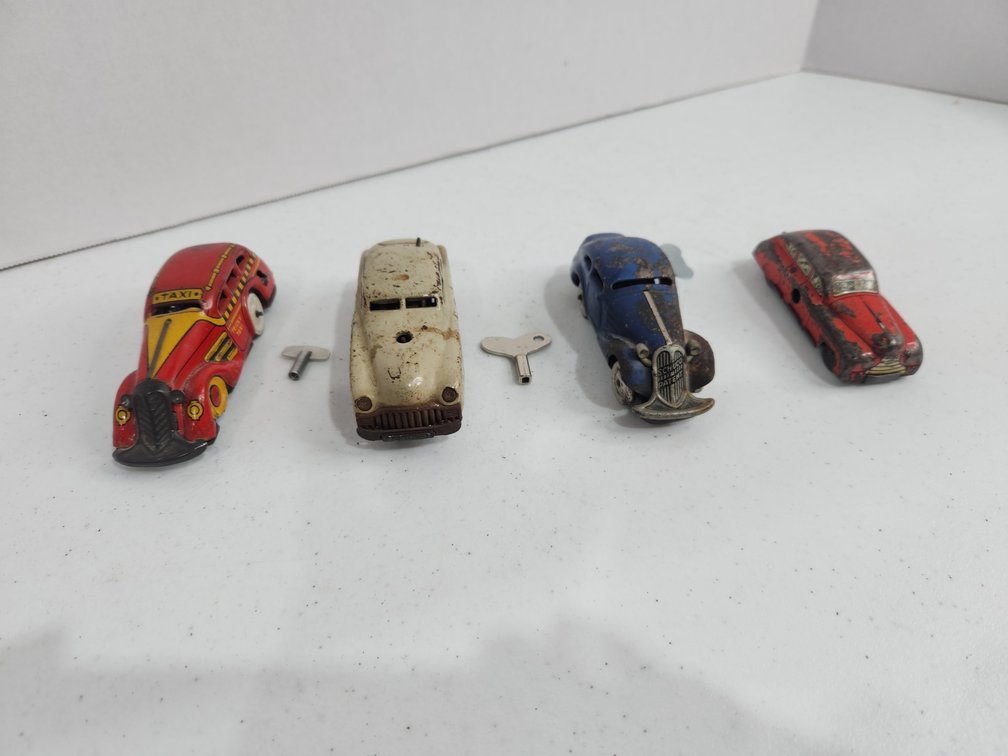 4 wind up tin litho cars 