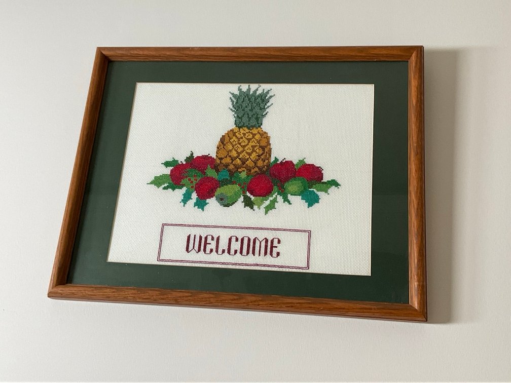 Framed Pineapple Welcome Needlework and Grapevine Metal Wall Wine Rack