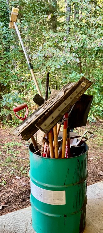 Assorted Long-Handle Landscaping and Utility Tools in Metal Drum